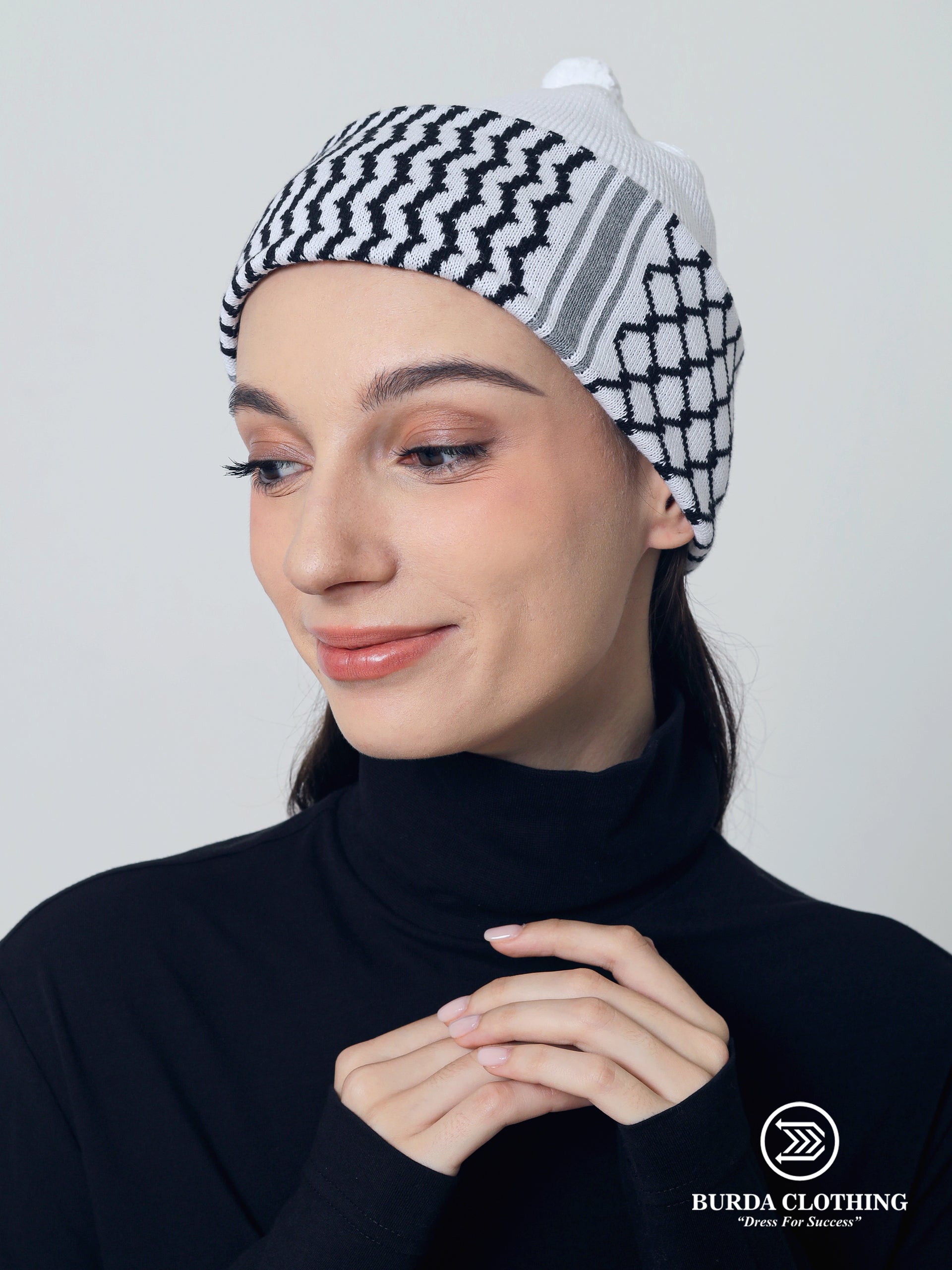 Woman wearing a black and white checkered beanie with Burda Clothing logo.